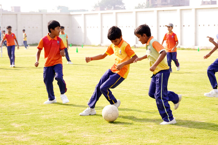 Students playing football on the school field